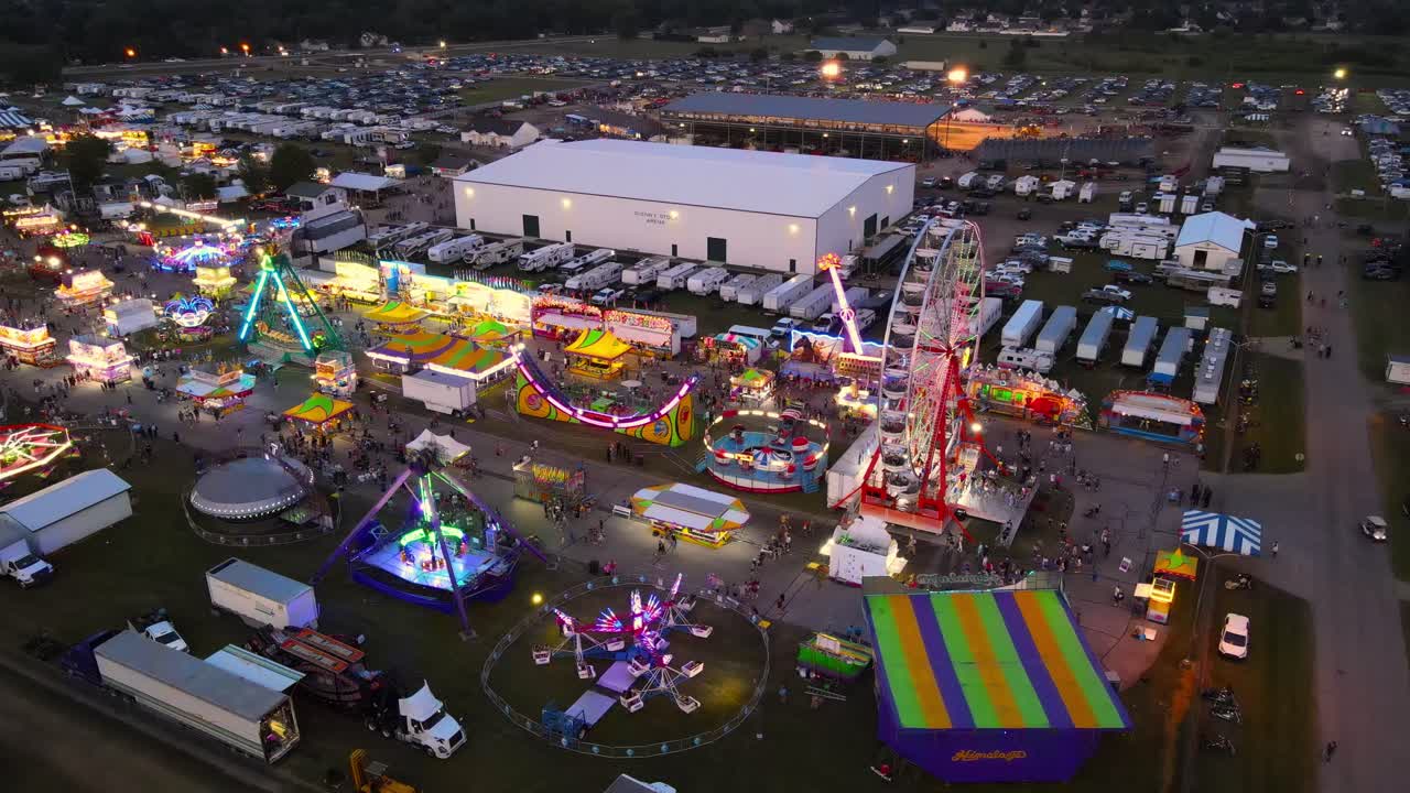 Aerial View of a Night Fair with Ferris Wheel and Rides