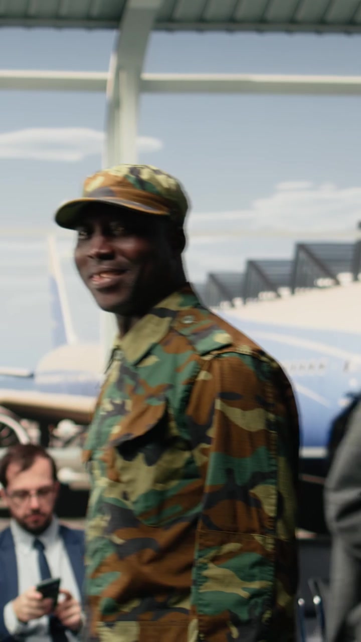 Vertikales Video: Gehende, international reisende und multiethnische Militäreinheit unterhält sich am Flughafen.
