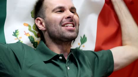 mexican fan celebrating while holding the flag of mexico in slow motion ,4k , high quality