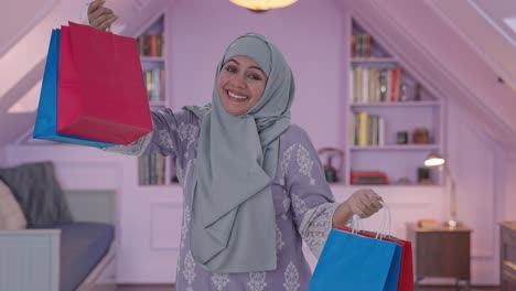 happy muslim woman doing shopping