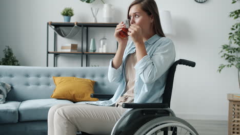 woman in wheelchair drinking tea