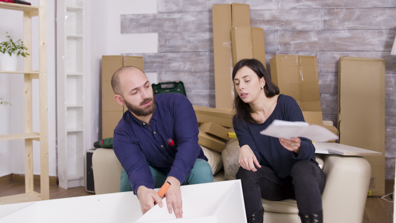 Couple assembling furniture at home