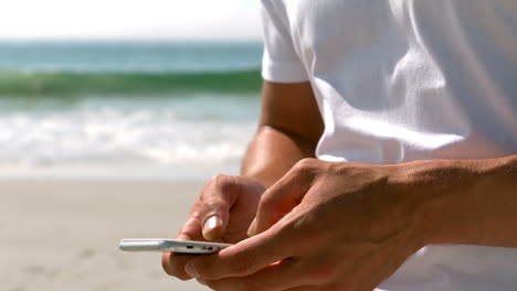 Handsome-man-wearing-white-using-smartphone