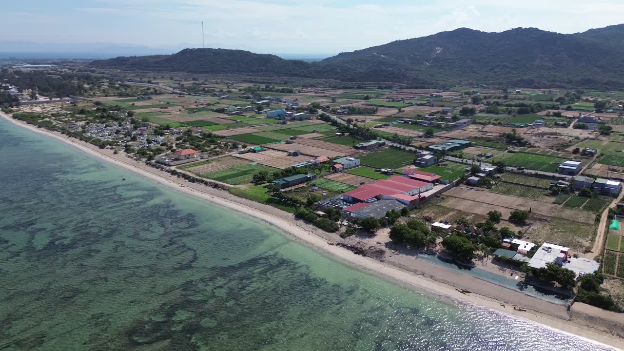 Semi orbit drone shot showcasing My Hoa Lagoon's pristine coastline and surrounding landscape in Phan Rang, Vietnam.