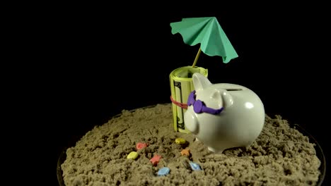 a white piggy bank stands on a sandy beach and revolves on a black background.