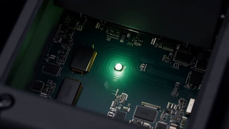 glowing green light on a circuit board