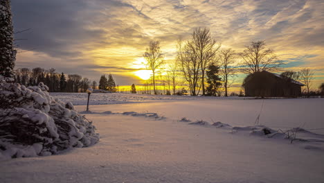 Watch-the-sky-paint-itself-in-a-timelapse-of-a-snowy-sunset-and-golden-rays-sun