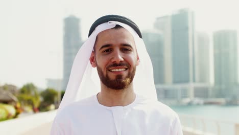 smiling man in traditional arabic dress