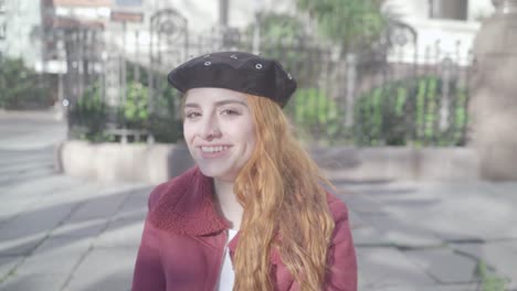portrait of smileing redhead woman posing with red sunglasses at photo shoot