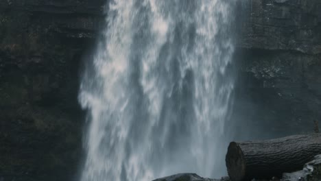 Panning-Down-Waterfall-Shot-with-Tree-Log-and-Stump-in-Wales-UK-4K