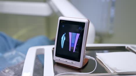 parameters changing on the sensor screen in dentistry office. advanced equipment in dental clinics. close up. blurred backdrop.