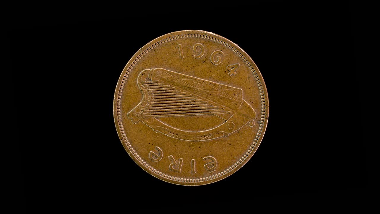 Ireland 1964 halfpenny coin obverse with Irish harp and date rotating on black background