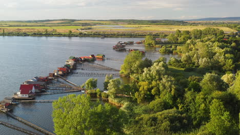 Hungarian-stilt-village-over-the-Bokodi-hutoto-lake,-drone-shot