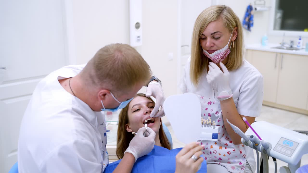Woman having visit at the dentist. Female patient having her teeth examined by specialist