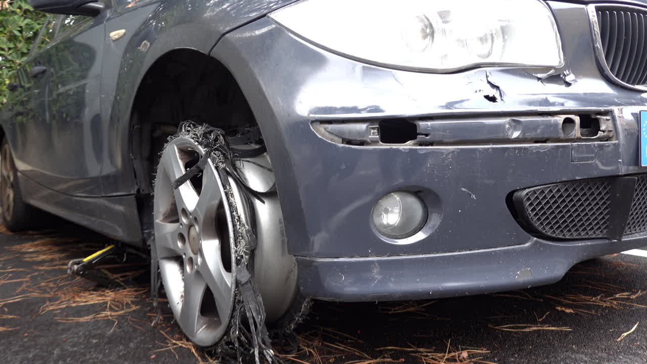 Cannes, France - March 19, 2025: Close up of the destroyed tyre of a grey car on the street