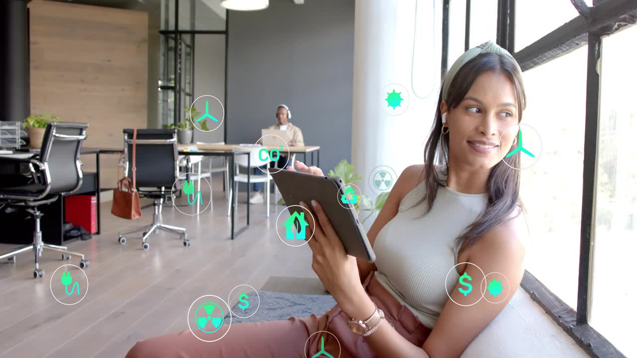 Woman tapping tablet in lounge, green icons appearing and clustering, creating AR energy dashboard