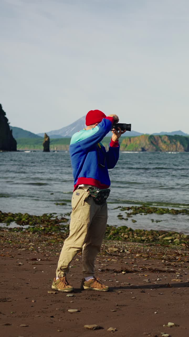 Man Photographer Taking Pictures of Scenic Ocean and Volcano Landscape