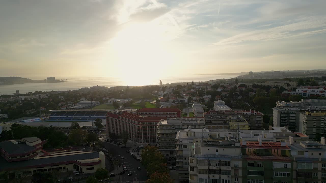 Cinematic aerial view of Lisbon from the Tagus River during a beautiful soft sunset
