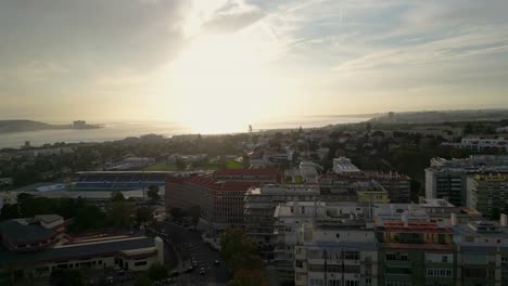 Cinematic-aerial-view-of-Lisbon-from-the-Tagus-River-during-a-beautiful-soft-sunset