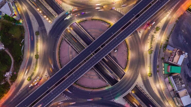 Aerial view of traffic time lapse on intersection circle. Busy traffic at night