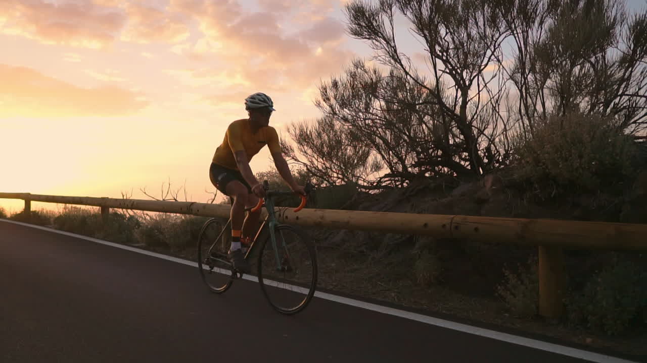 In slow motion, the biking athlete journeys along a mountain serpentine, marveling at the island's view—a manifestation of a healthy lifestyle