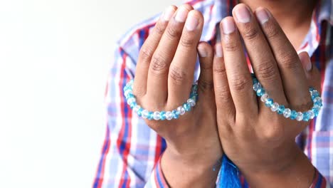 muslim person praying with prayer beads