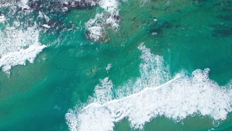 Perfect-sea-waves-washing-upon-mountain-beach-shore-in-Playa-de-Tagle,-Spain