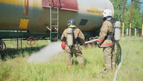 firefighters responding to a simulated fire at a railroad tank car