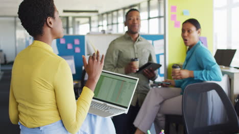 african american business people having meeting and using laptop at office, slow motion