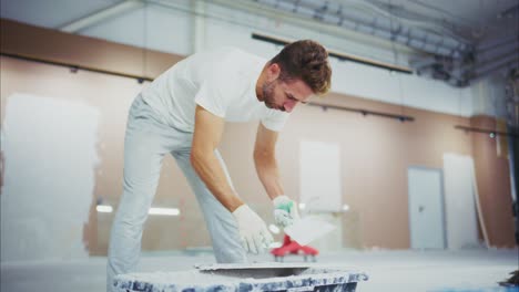 a dedicated worker expertly applies finishing touches to freshly painted walls, showcasing the commitment and skill involved in renovation and maintenance projects
