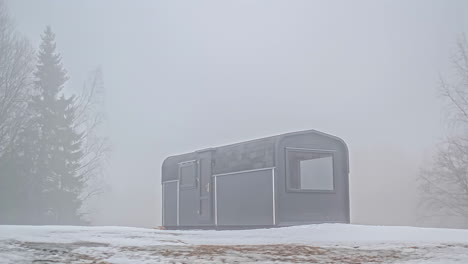 thermo wood cabin in winter forest during daylight till sunset