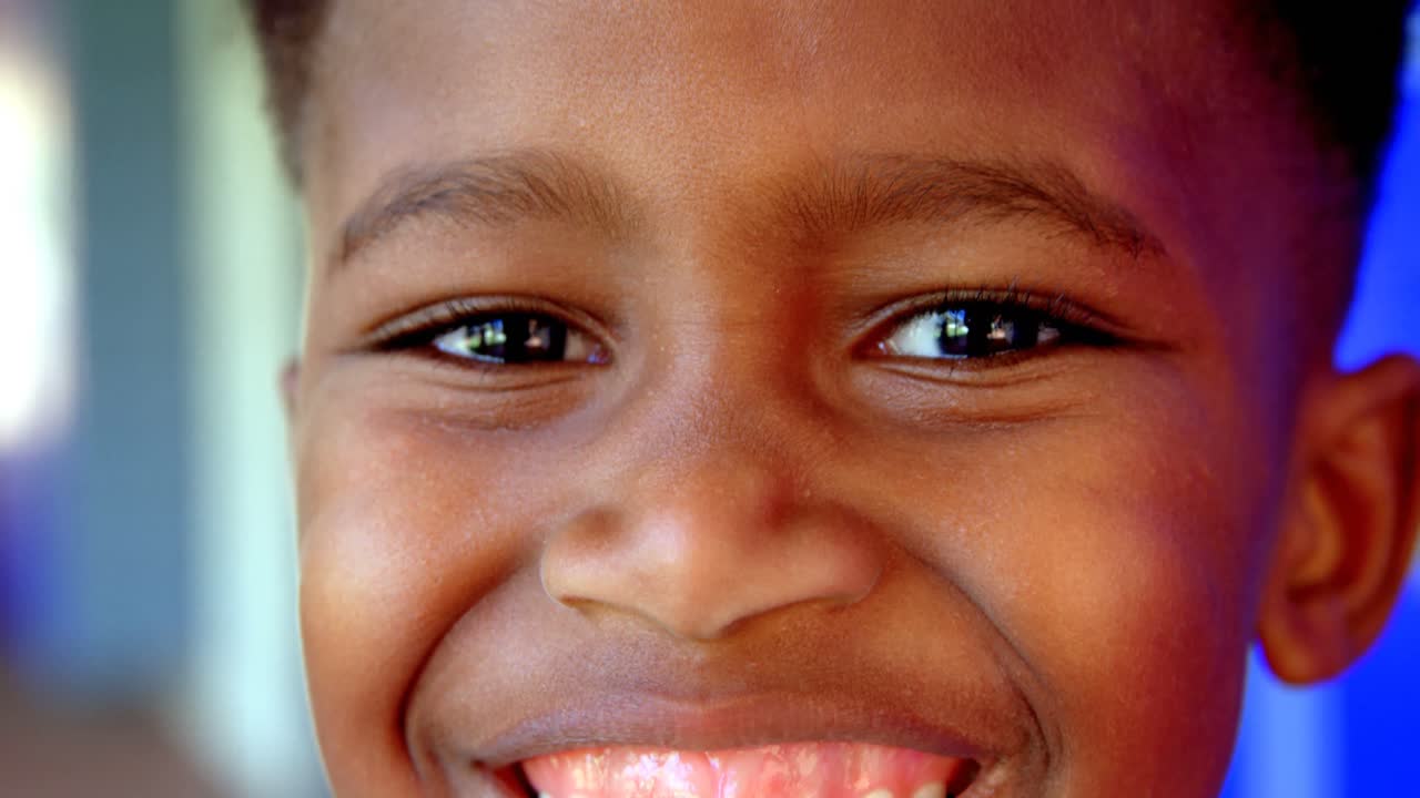 Close-up of happy African American schoolboy standing in school corridor 4k