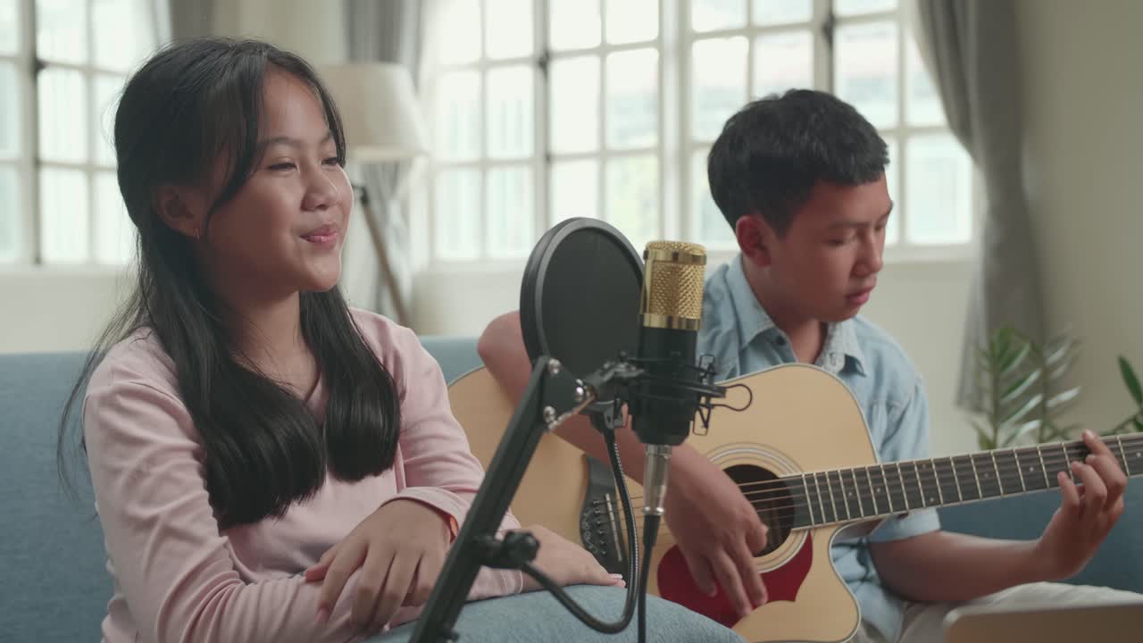 Girl and Boy Singing and Playing Guitar