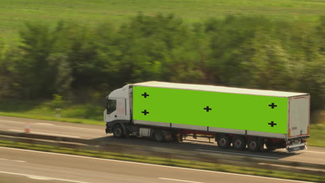 truck on highway with green screen trailer