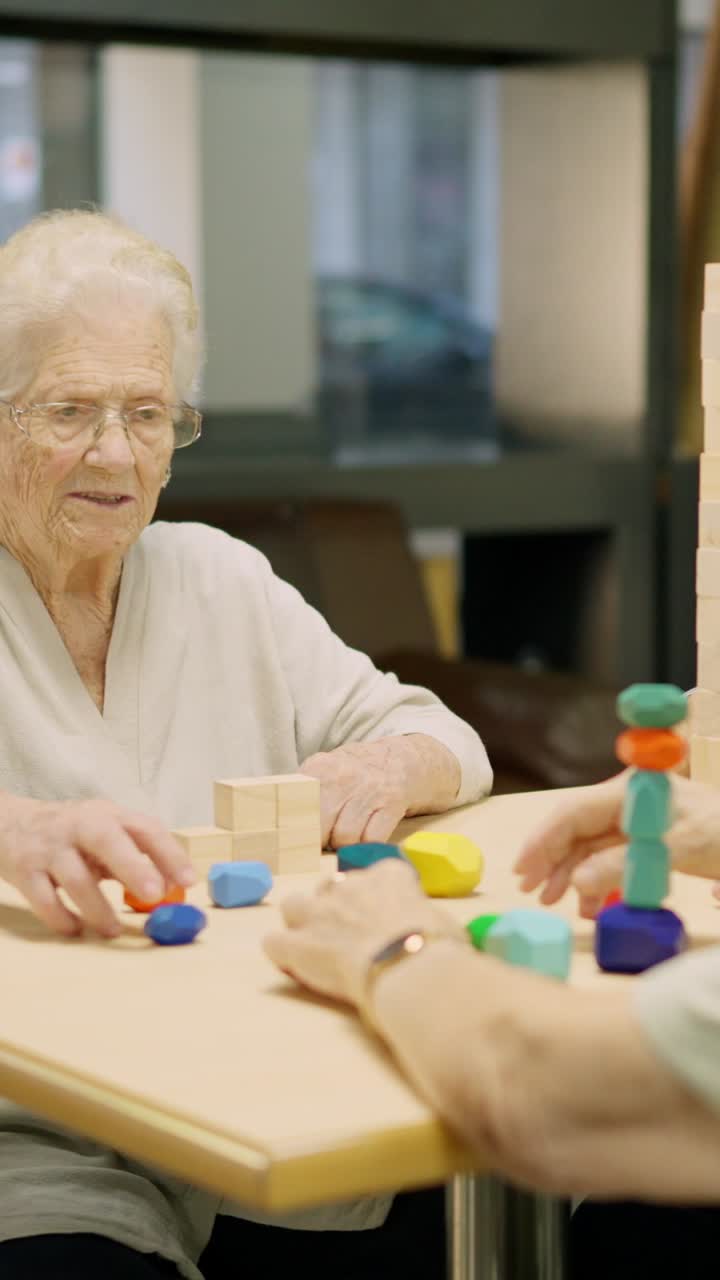 Elderly woman playing with blocks