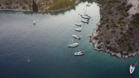 Vista-Aérea-De-Una-Playa-Solitaria-Salvaje-En-La-Costa-De-La-Isla-De-Brac,-Croacia,-Mar-Adriático,-Donde-Están-Anclados-Veleros-De-Lujo