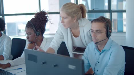 young manager helping call center operators