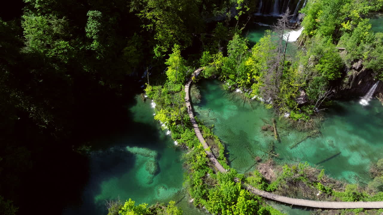 Path Between The Lakes With Crystal Clear Water In Plitvice Lakes National Park, Croatia. - aerial shot