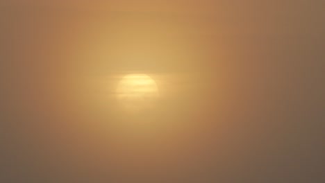 sunrise timelapse during cloudy foggy hazy morning, sun revealing itself behind clouds medium shot, maffra, gippsland, victoria, australia