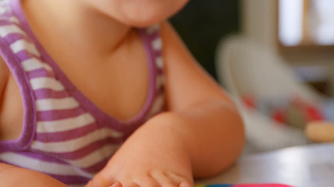chica linda jugando con arcilla de colores en un hogar cómodo 4k