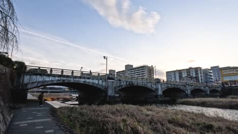 bridge and buildings at sunset in osaka