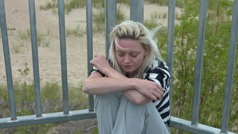 lonely woman in pain alone outside in windy weather