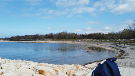 View-of-a-rocky-shore-,-a-wide-blue-ocean-and-a-brilliant-blue-sky