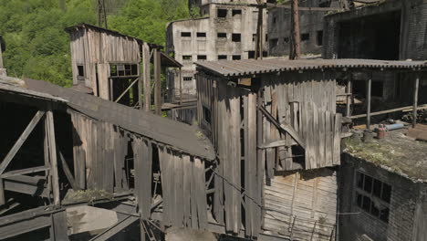 Crude-wooden-skywalk-and-leaking-sewage-drain-pipe-in-abandoned-mine