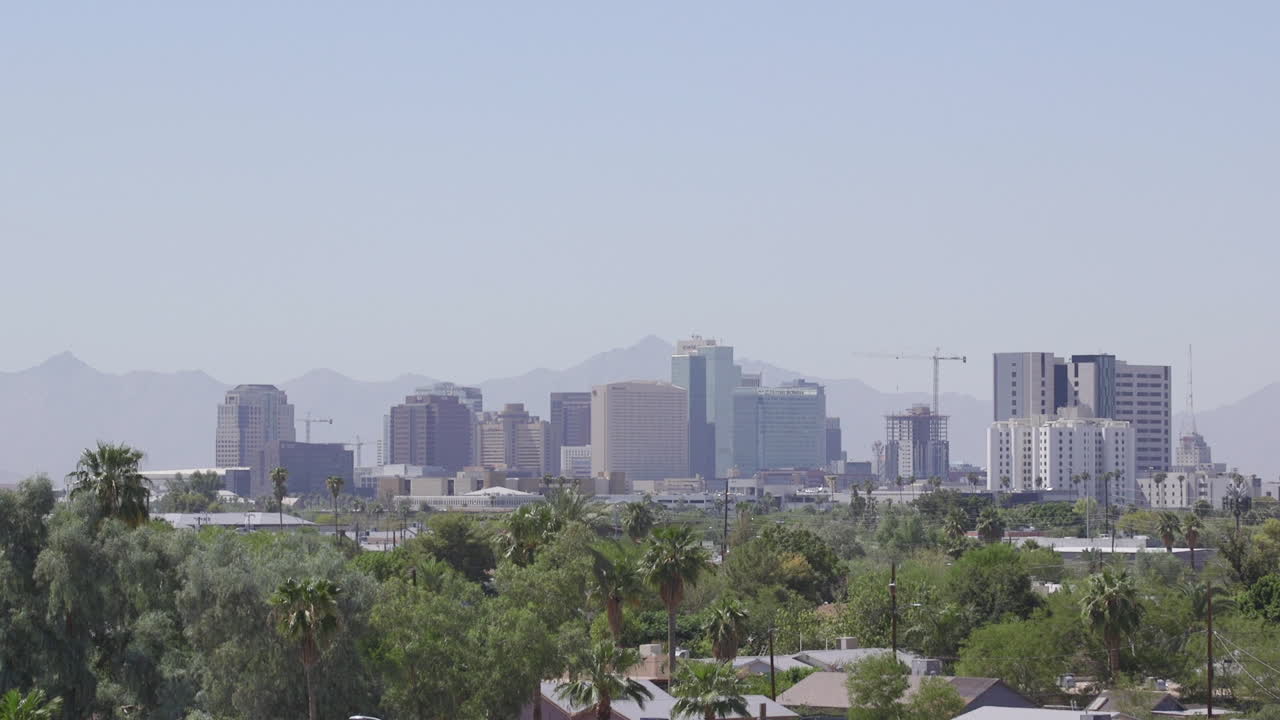 Establishing shot of Downtown Phoenix Arizona with mountains behind it. Medium Wide Shot