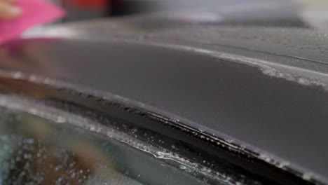 removing air bubbles after car wrapping with adhesive film, close up