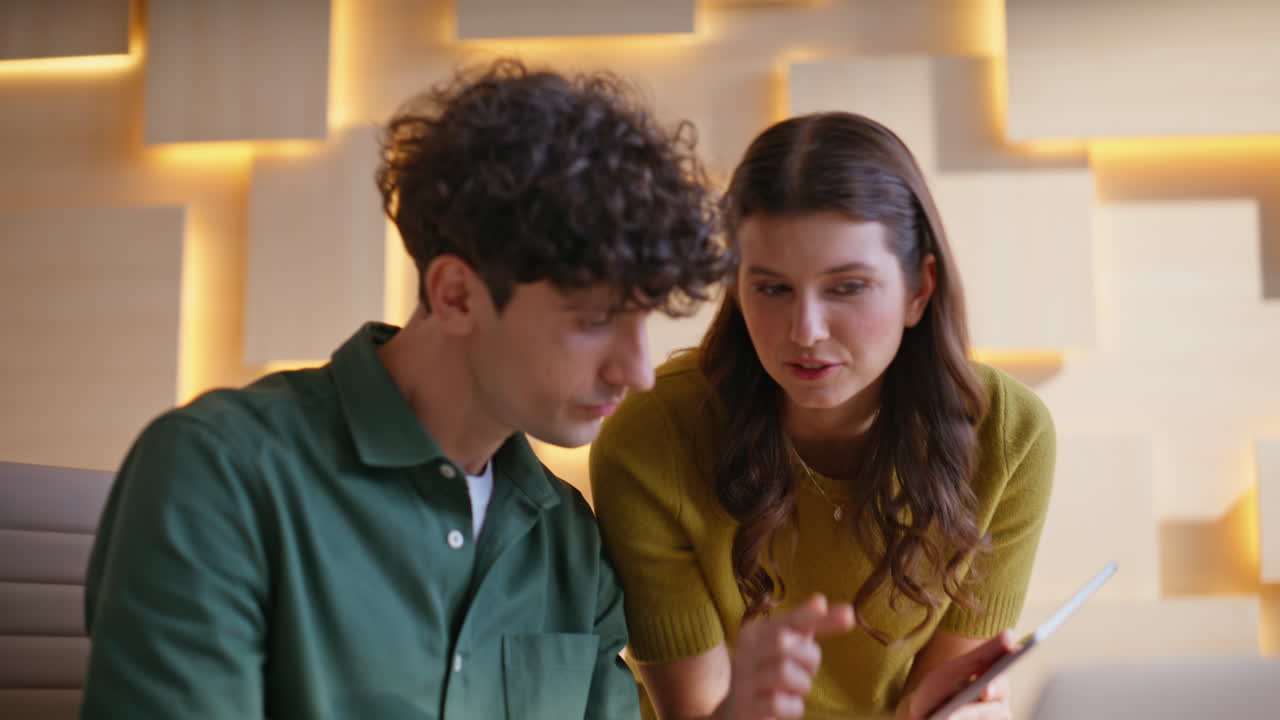 Two people looking at a tablet