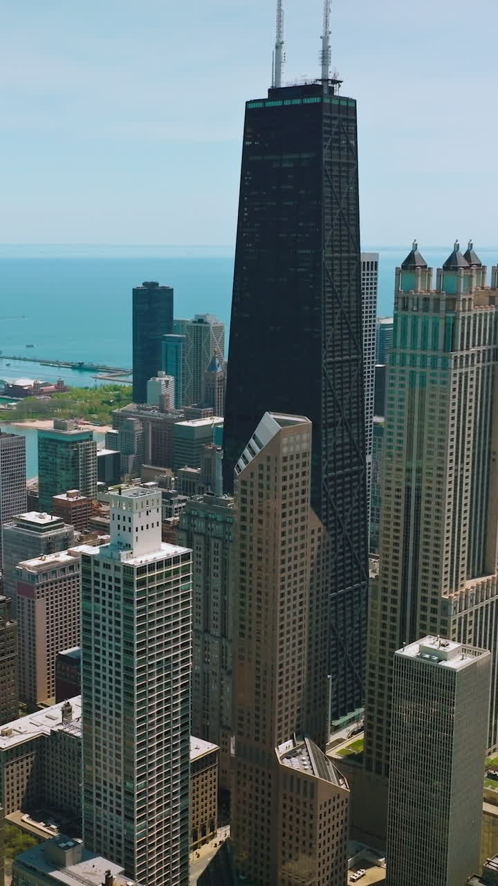 Luxurious skyscrapers of Chicago, Illinois on sunny clear day. Beautiful architecture at the backdrop of blue waters of Lake Michigan. Vertical video