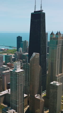 luxurious skyscrapers of chicago, illinois on sunny clear day. beautiful architecture at the backdrop of blue waters of lake michigan. vertical video