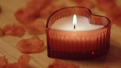 heart-shaped candle with rose petals